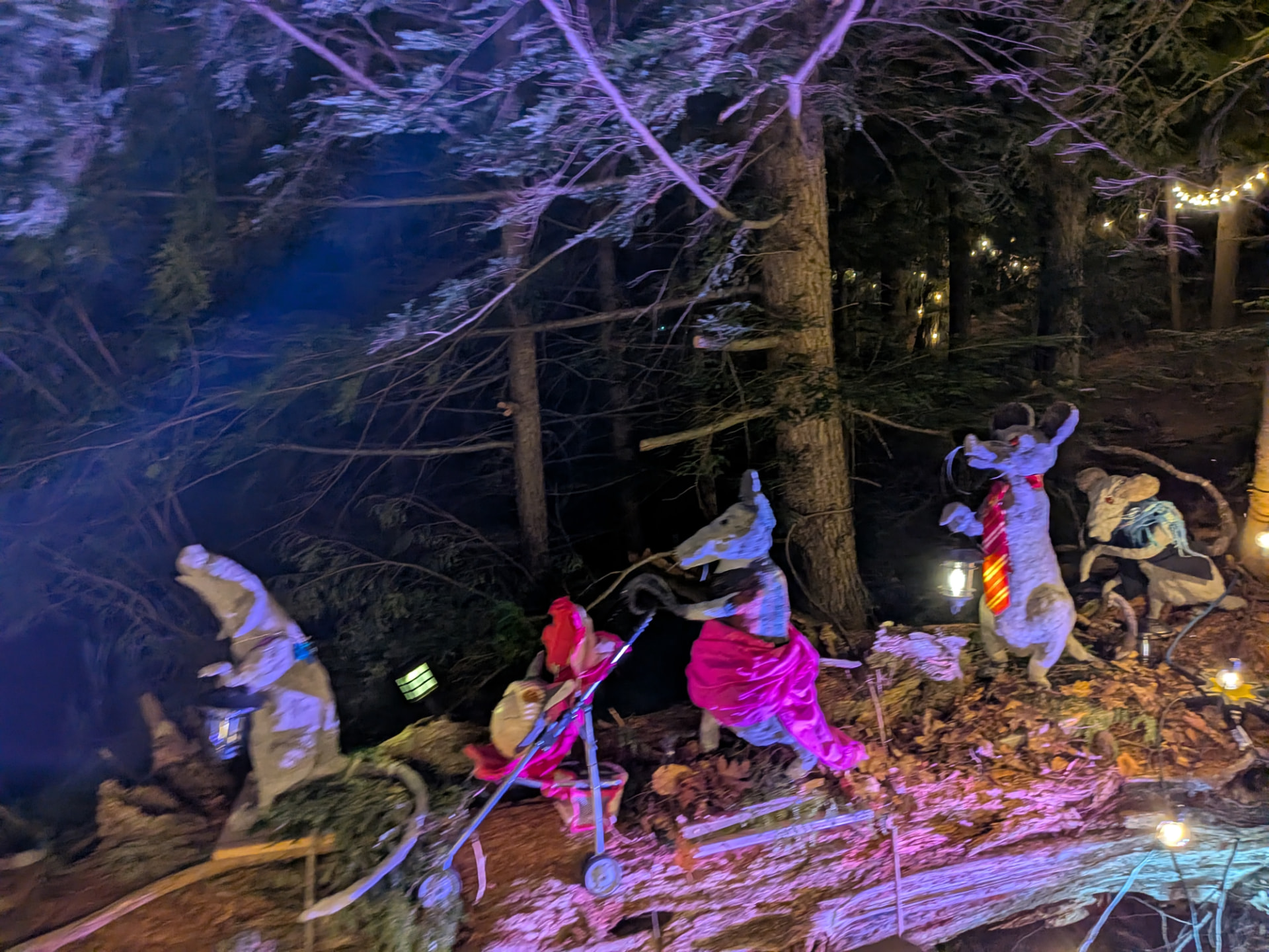 Rats in pink silk and a stroller crossing the log under violet light